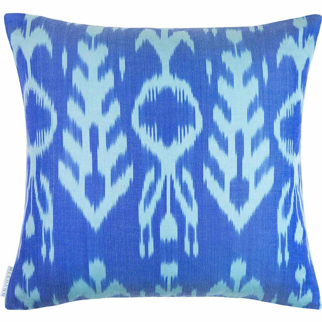 Back view of Mekhann's blue and multicoloured embroidered cushion, showcasing the bright coloured blue ikat lining of the cushion.