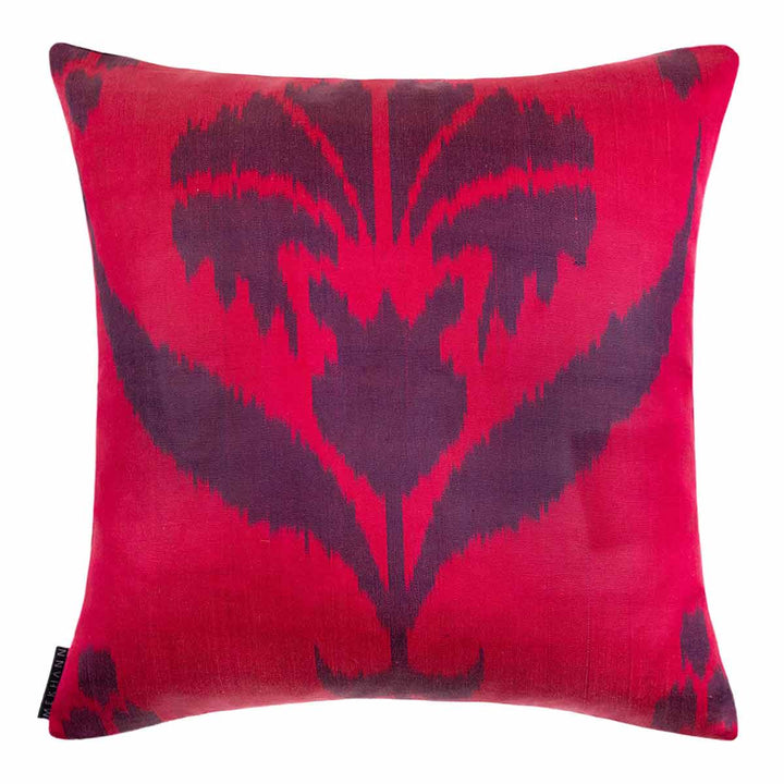 Back view of Mekhann's red and black carnations embroidered cushion, showing the pink ikat back lining in full view.