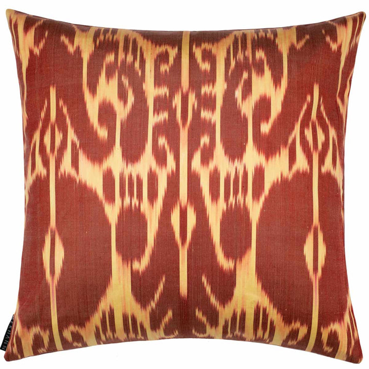 Back view of Mekhann's tulips and carnations embroidered cushion, where we can see a bold brown and beige ikat back lining of the cushion.