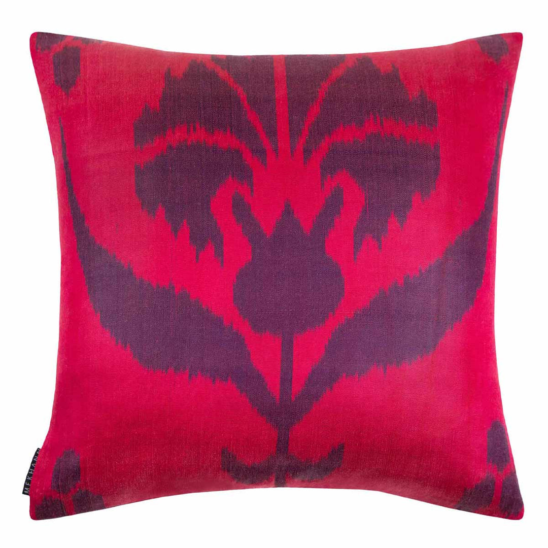 Back view of Mekhann's multicoloured lotus embroidered cushion,  exposing a full view of the pink ikat back face of the cushion.