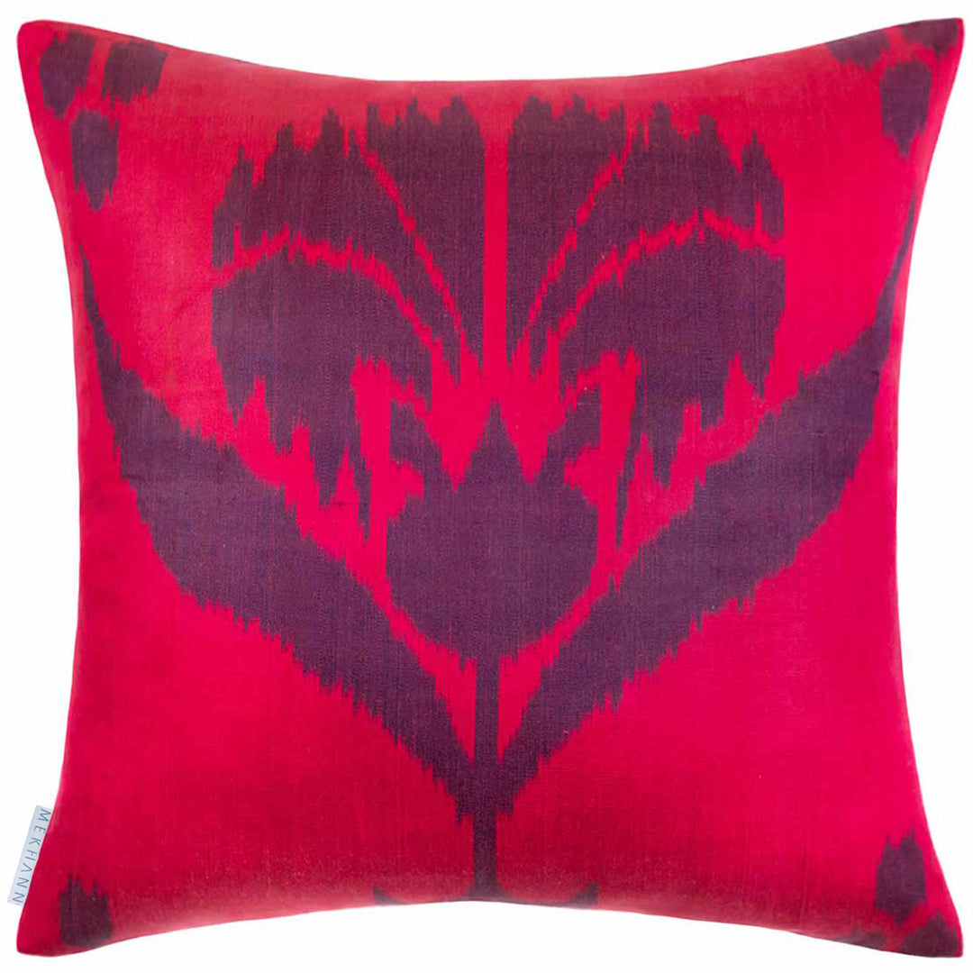 Back view of Mekhann's multicoloured abstract embroidered cushion, showing the bright pink ikat back lining of the cushion.