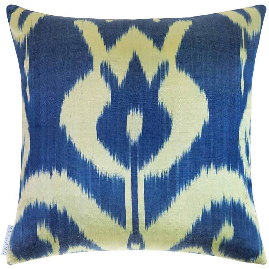 Back view of Mekhann's multicoloured pomegranate embroidered cushion, showing a view of the ikat back lining in blue and cream.