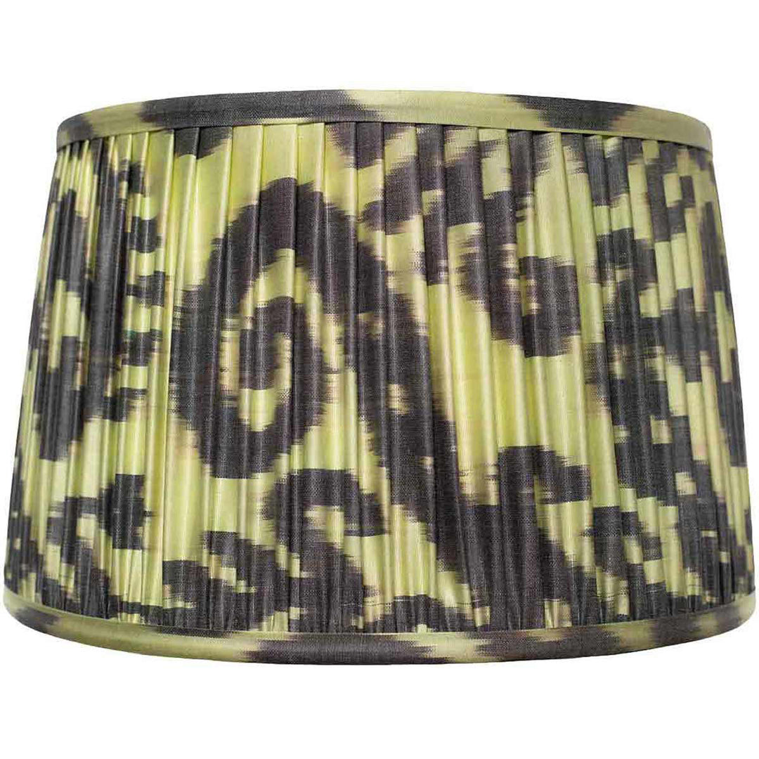 Front view of Mekhann's black and green ikat silk lampshade, showcasing hand-pleated artistry with eco-friendly dyes.
