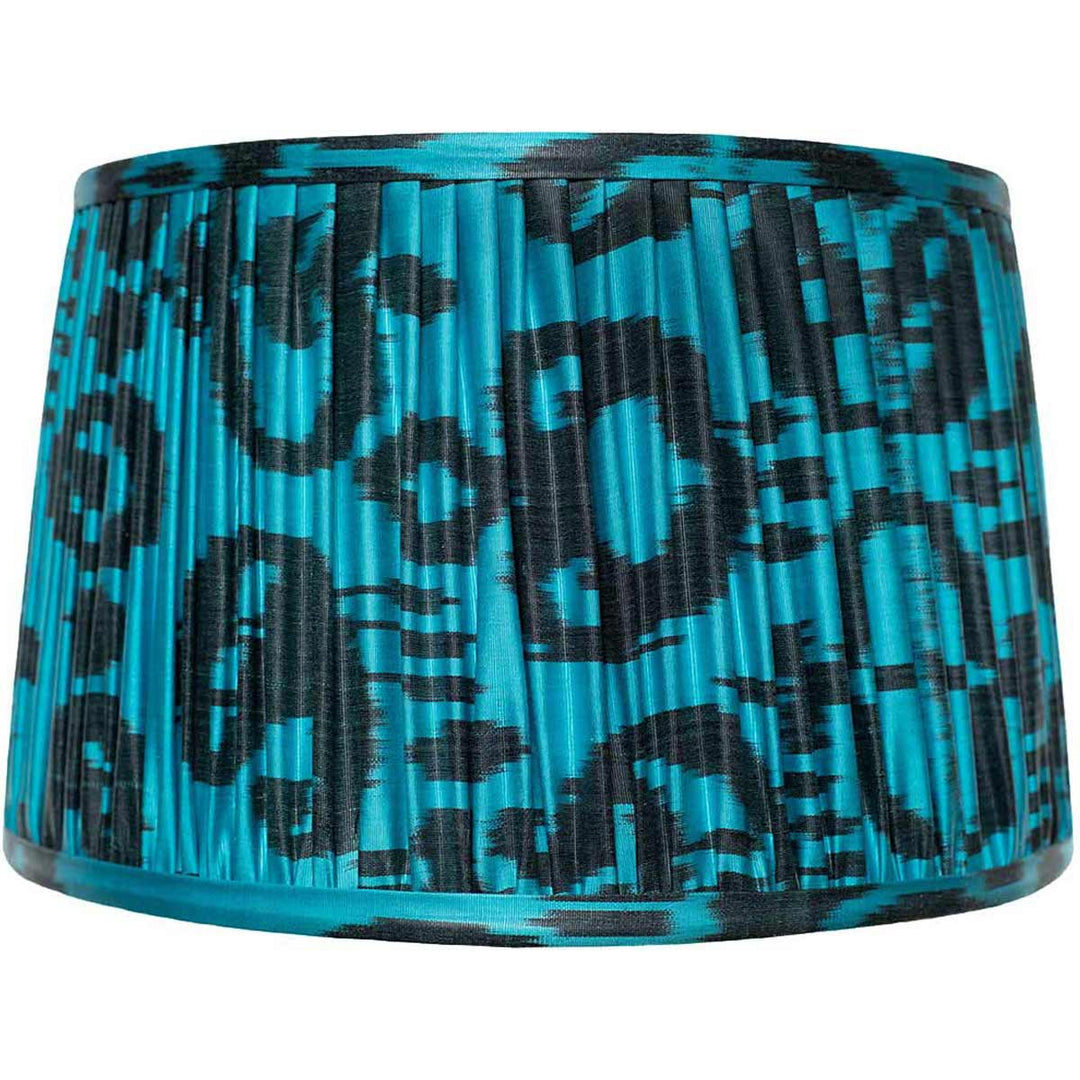 Front view of Mekhann's black on blue ikat silk lampshade, hand-pleated with natural dyes for a striking visual contrast.