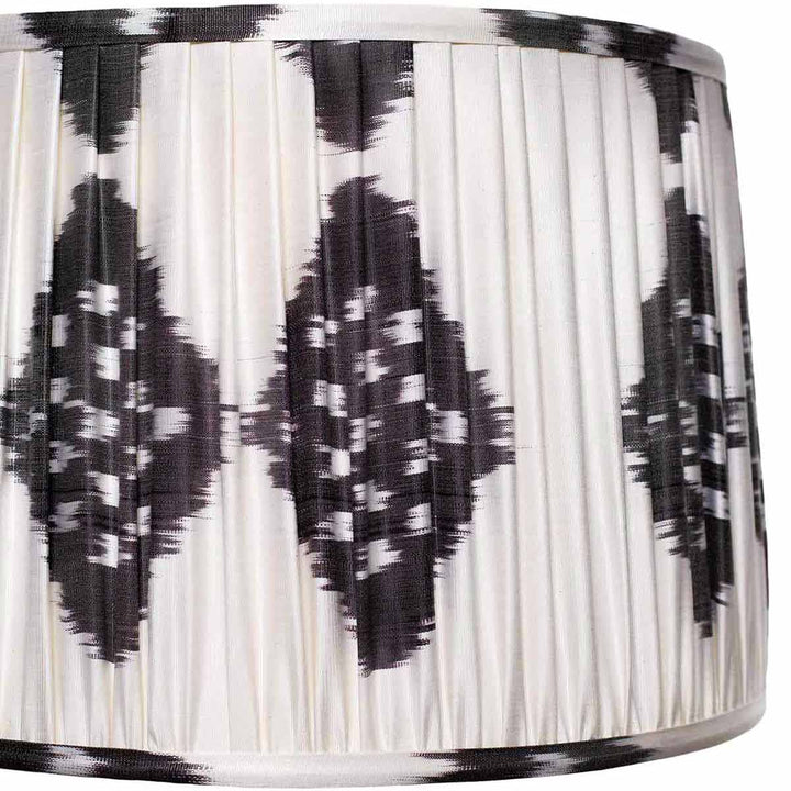 Close-up of the intricate black and white ikat pattern on Mekhann's silk lampshade, a testament to sustainable luxury.