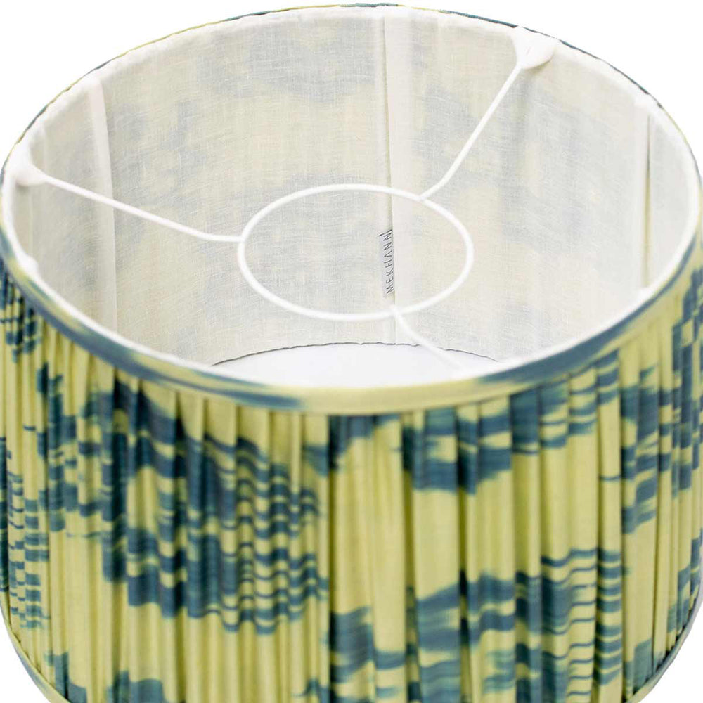 Interior shot of Mekhann's silk lampshade with blue and lime ikat design, reflecting the brand's dedication to artisanal craftsmanship.
