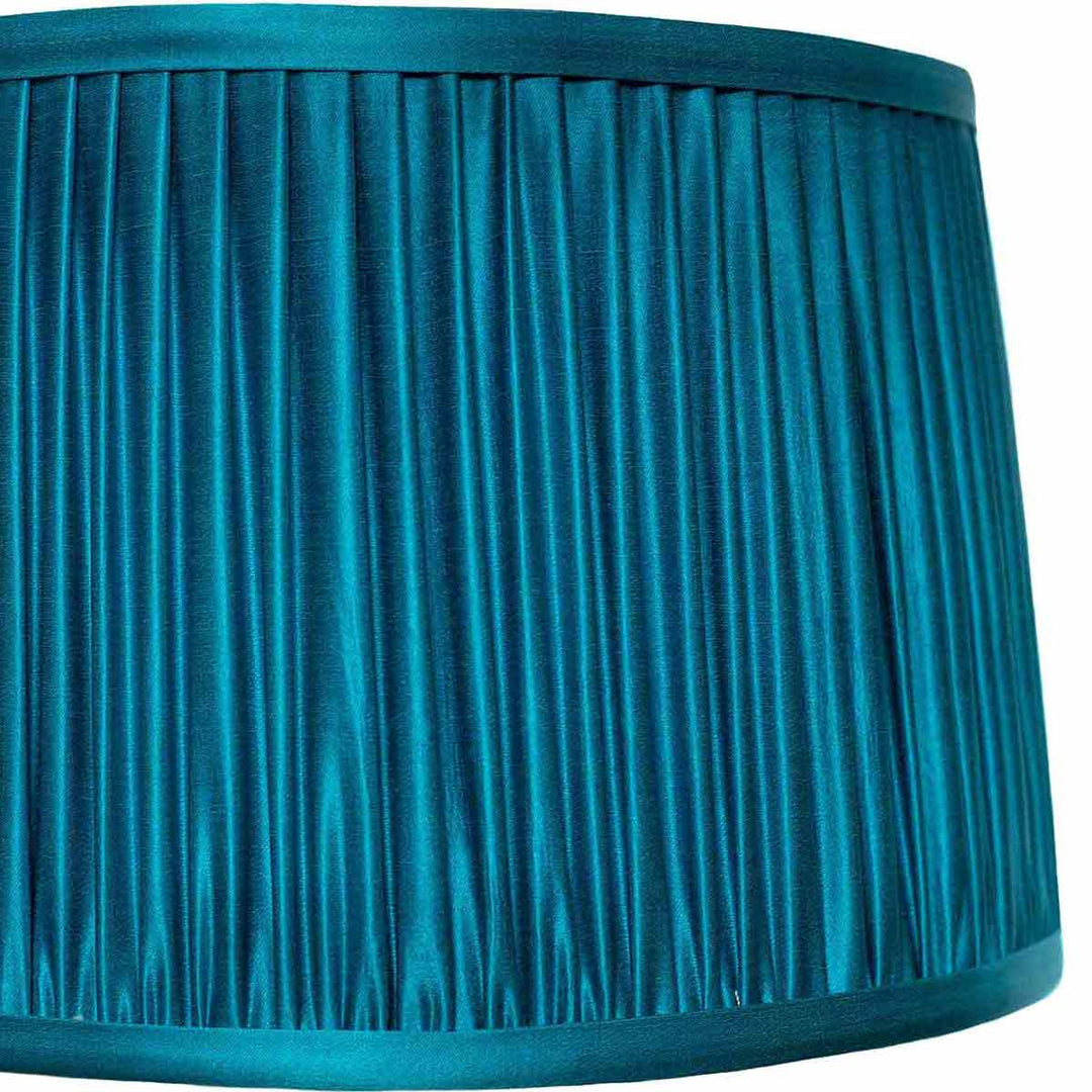 Close-up of Mekhann's blue silk lampshade, showcasing the meticulous hand-pleating technique and rich, sumptuous colour.