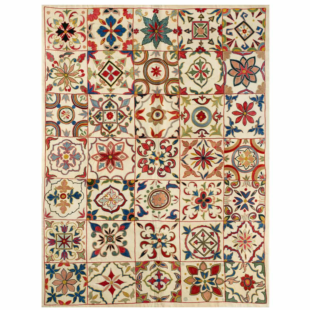 Front view of Mekhann's botanical mosaic throw, displaying all hand embroidered design elements that make up the full composition of the throw.