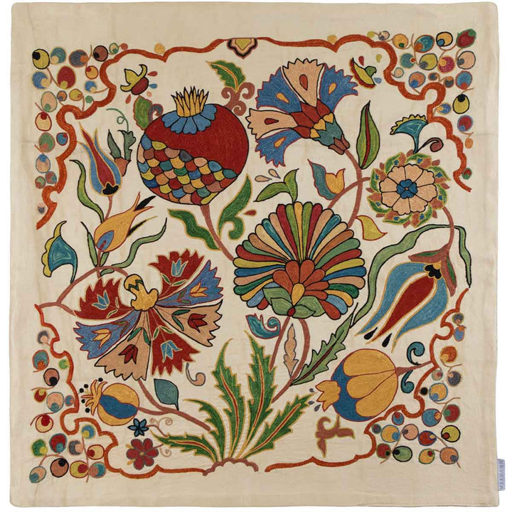 Front view of Mekhann's botanical cream petite throw,  featuring intricate embroidered botanical patterns with decorative elements in vibrant colours, all set on a canvas of cream coloured silk.