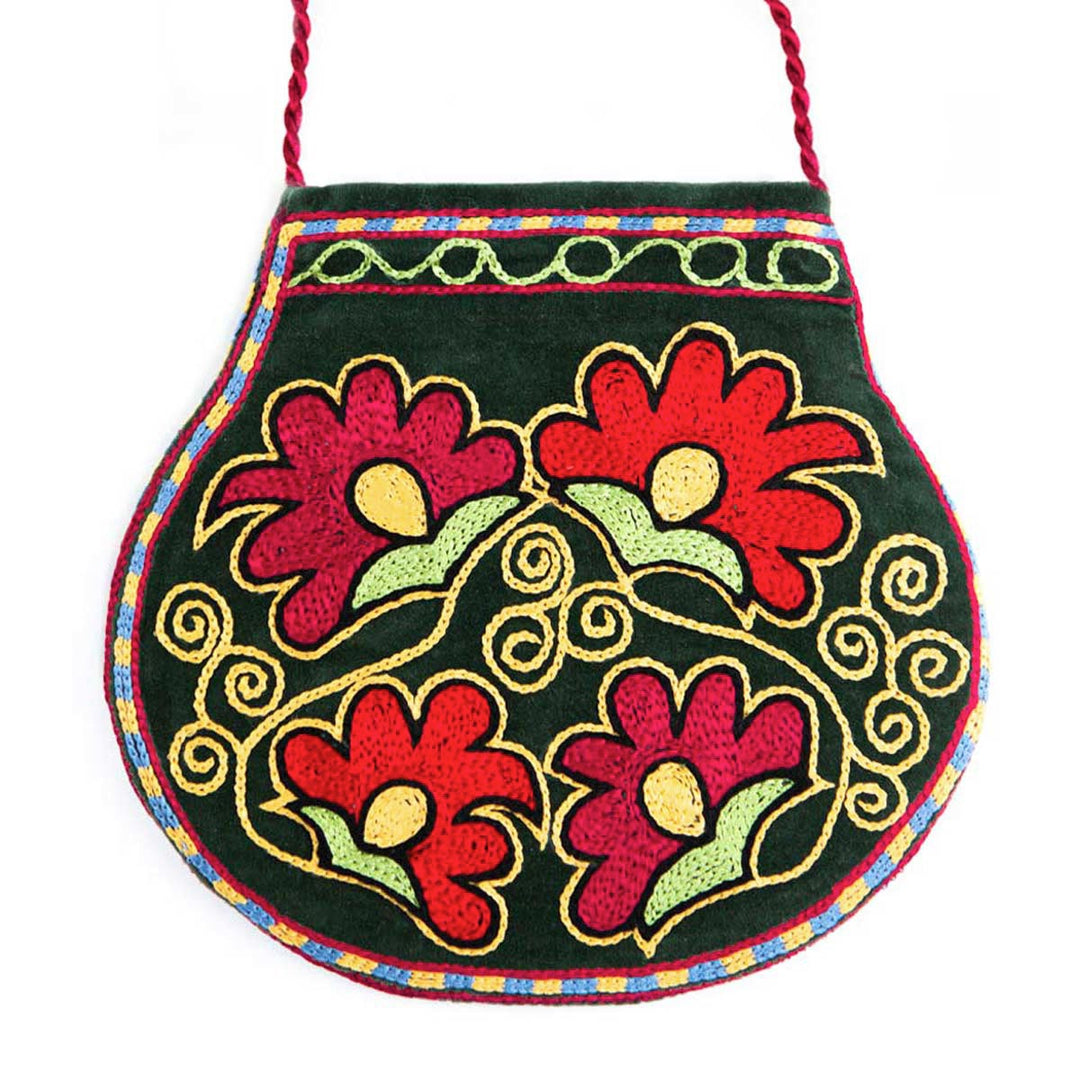 Front view of Mekhann's botanical dark green velvet pouch, displaying four bright pink and red flowers against a deep green velvet.