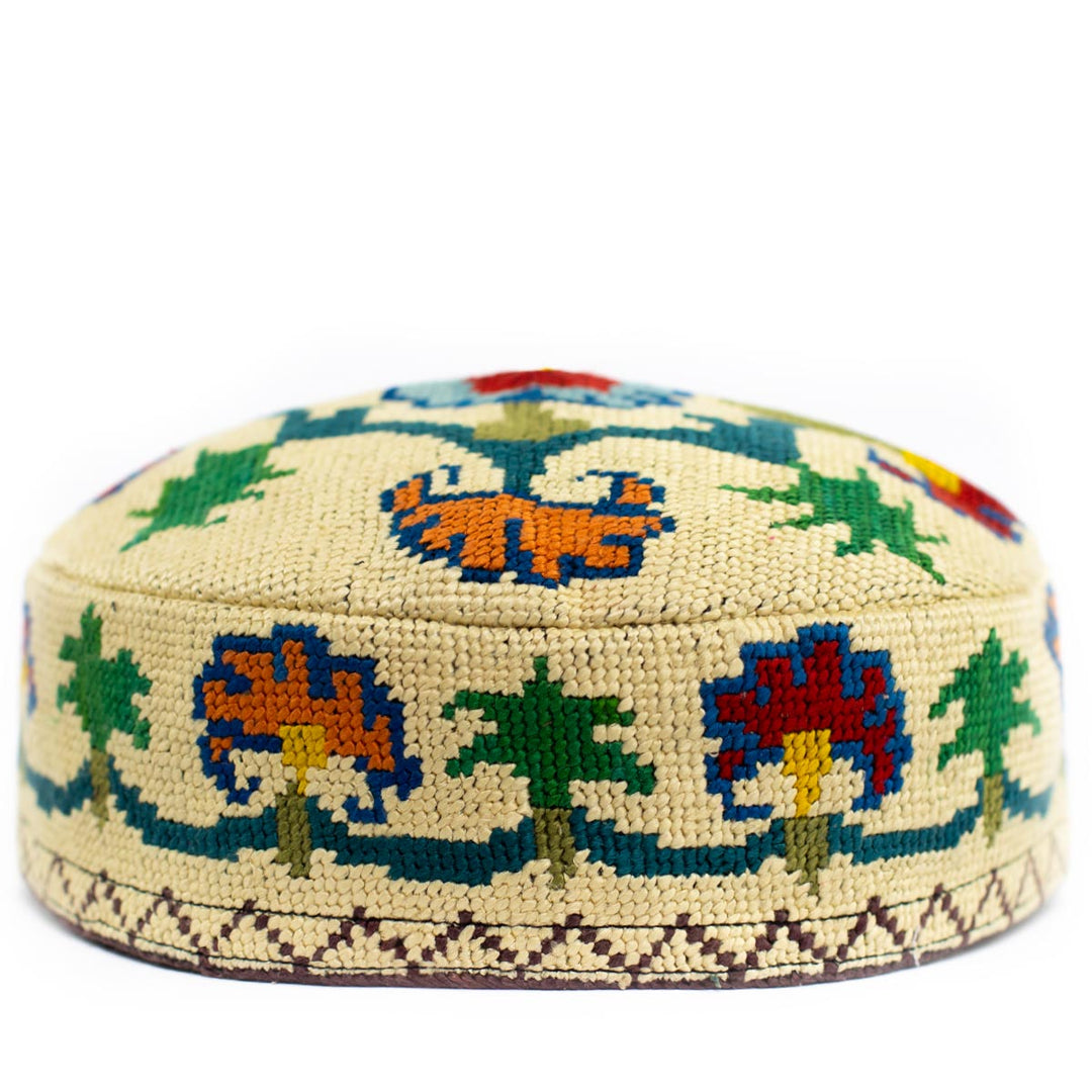Front view of Mekhann's botanical cream skull cap, showing a wonderful display of colourful flower patterns and shapes in red, orange and green hues.
