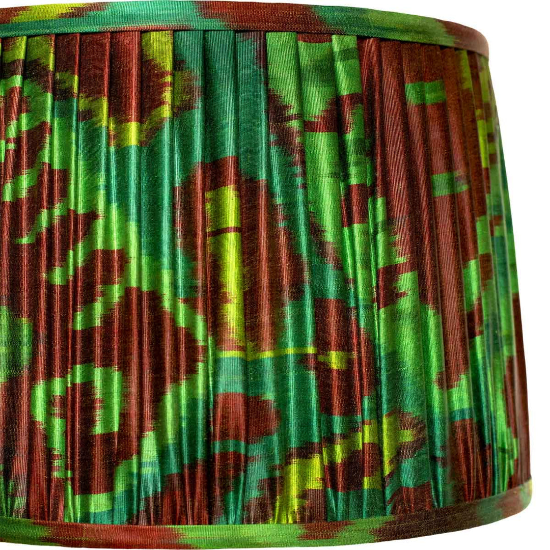 Colorful pleated fabric with green and red pattern on a white background