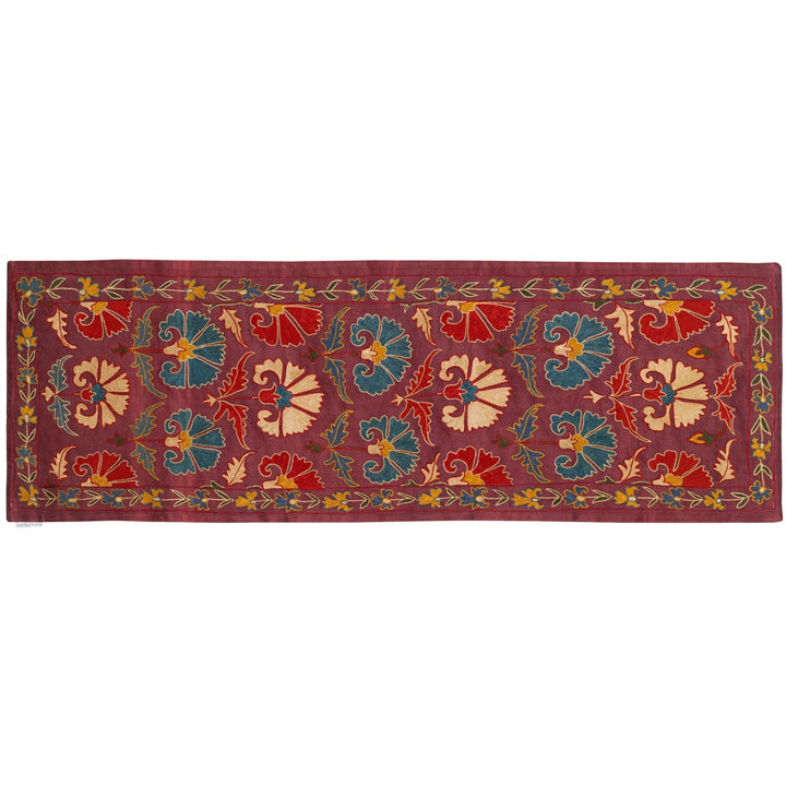 Horizontal front view of Mekhann's purple carnations petite throw, displaying an alternative placement of the runner.