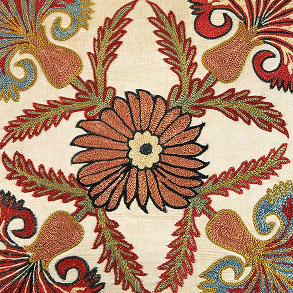Close up view of Mekhann's cream carnations embroidered cushion, showing the central brown and cream floral detail that the carnations emerge from.