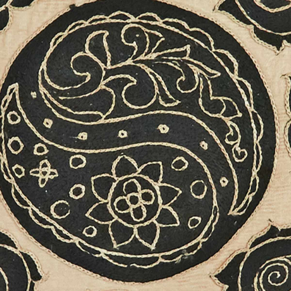 Close up view of Mekhann's hand embroidered silk abstract cushion in cream. Revealing the black embroidered abstract detailing on a cream silk base.