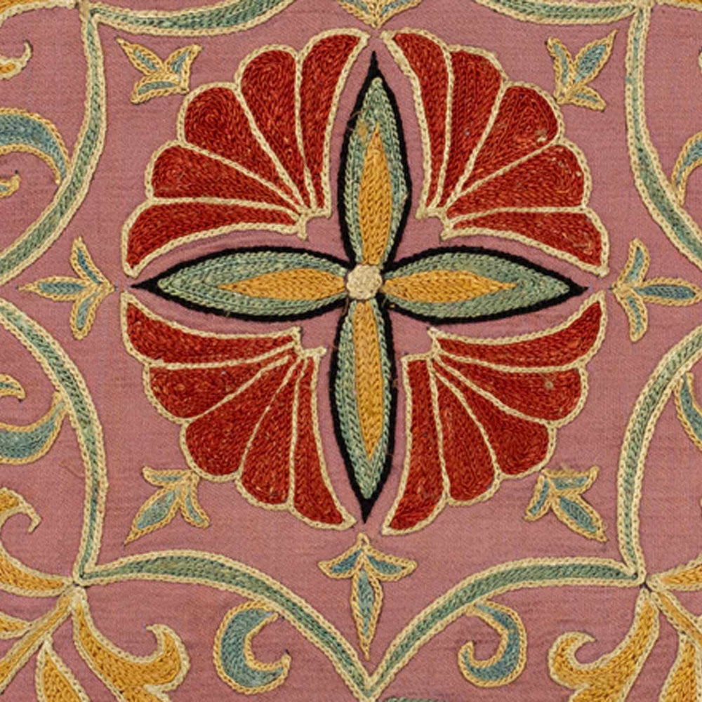 Close up view of Mekhann's tulips and carnations embroidered cushion, where we can see one of the red flower motifs up close revealing the texture of the silk threads.