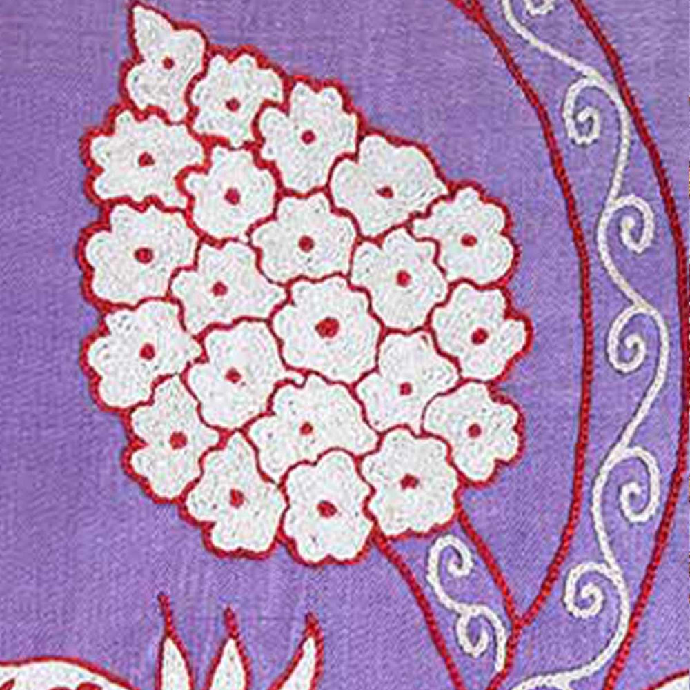 Close up view of Mekhann's grapes and pomegranates embroidered cushion, showing one of the cream and red grapes motif up close.
