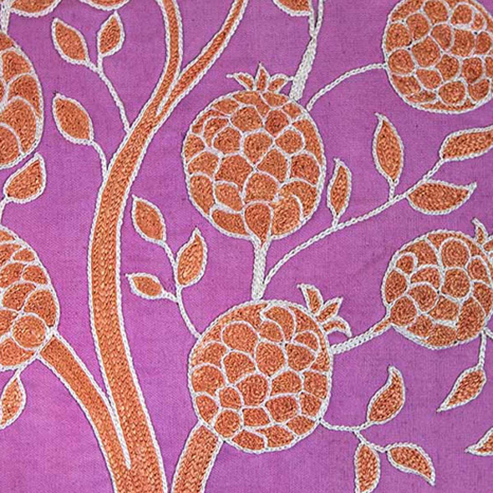 Close up view of Mekhann's purple pomegranate embroidered cushion, showing the pomegranates have been hand embroidered in beige and outlined in a light cream all on a silk base of purple.