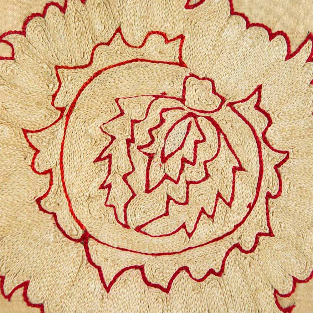 Close up view of Mekhann's cream botanical throw, where we can see all the different directions of the silk yarns and how each stitch has been carefully place in order to create this floral design motif.