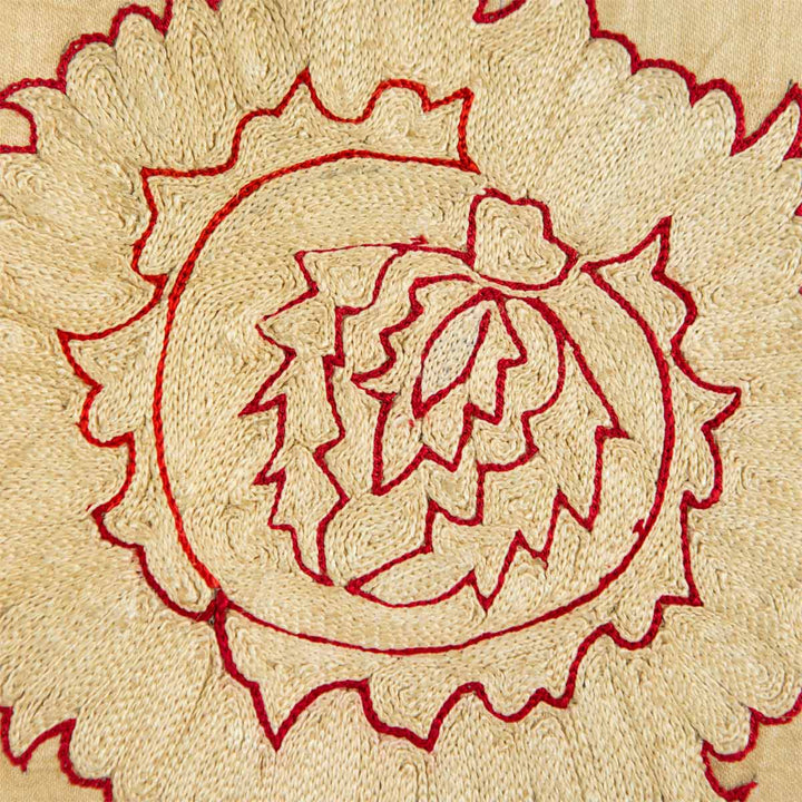 Close up view of Mekhann's cream botanical throw, where we can see all the different directions of the silk yarns and how each stitch has been carefully place in order to create this floral design motif.