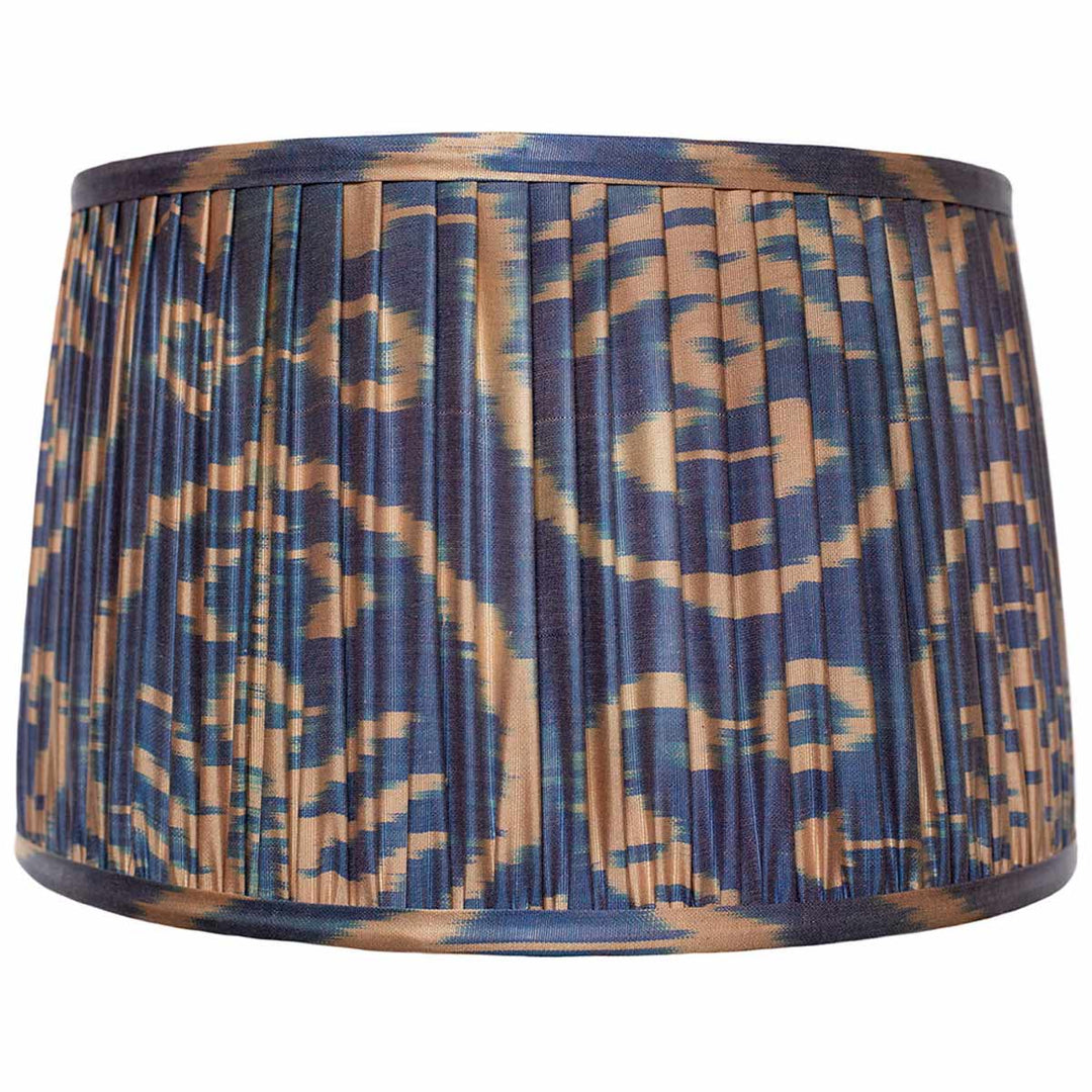 Front view of Mekhann's cream on navy ikat silk lampshade, hand-pleated with natural dyes for an elegant contrast.