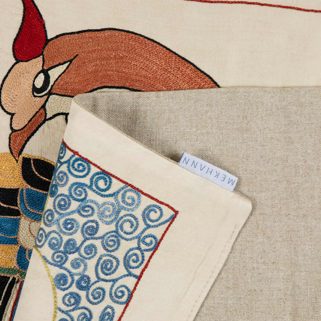 Elegant side view of Mekhann's silk embroidered throw, focusing on the richly colored double-headed eagle design, ideal for sophisticated interior accents.