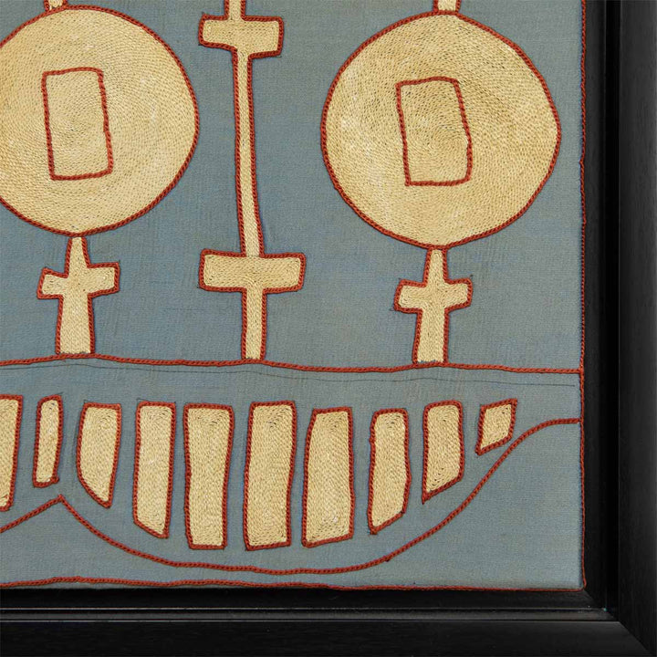 Corner view of Mekhann's grey silk embroidered tent artwork, where we can see the point the silk textile artwork end and meeting the black frame.