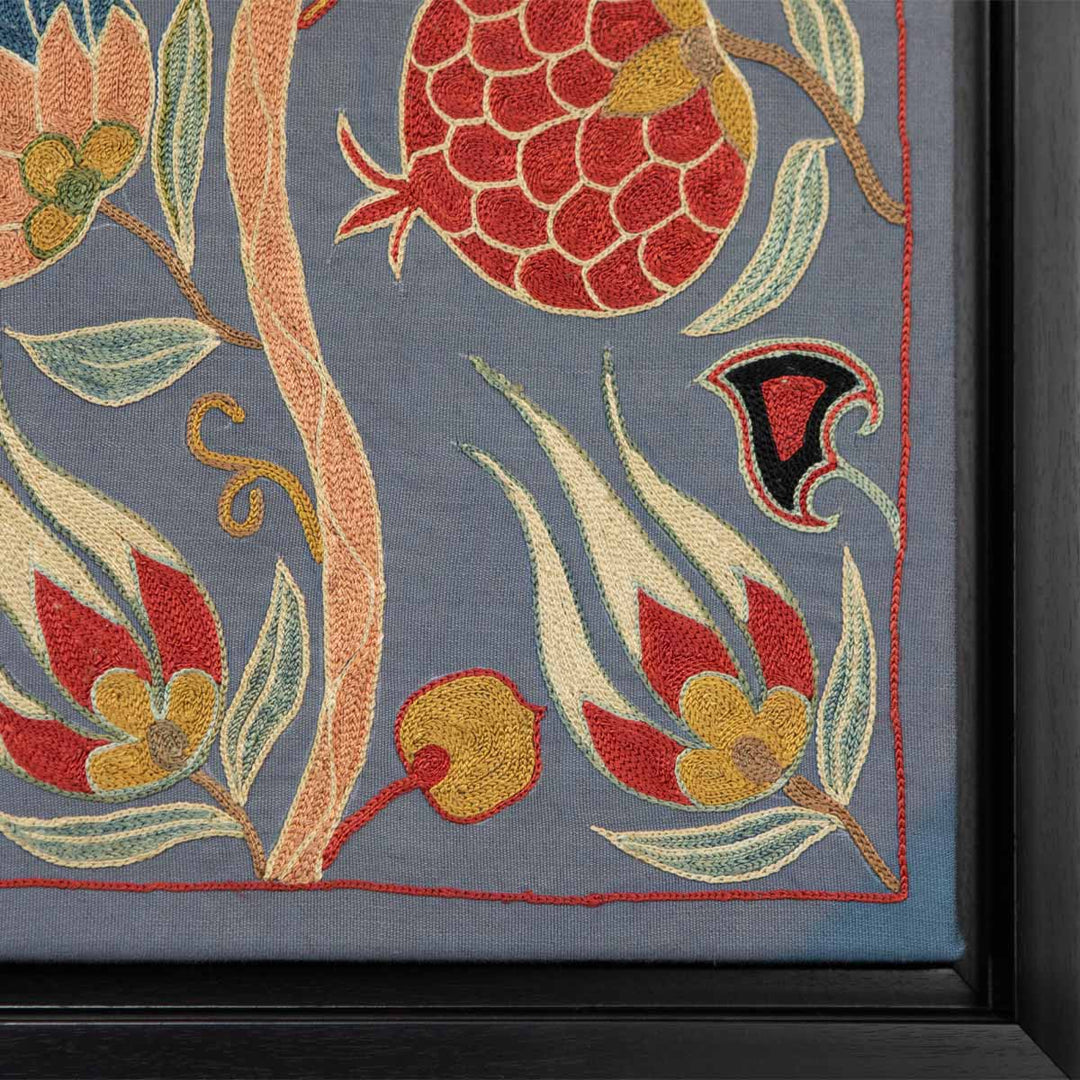 Corner view of Mekhann's grey silk botanicals artwork, showing where the artwork ends and the black frame begins.