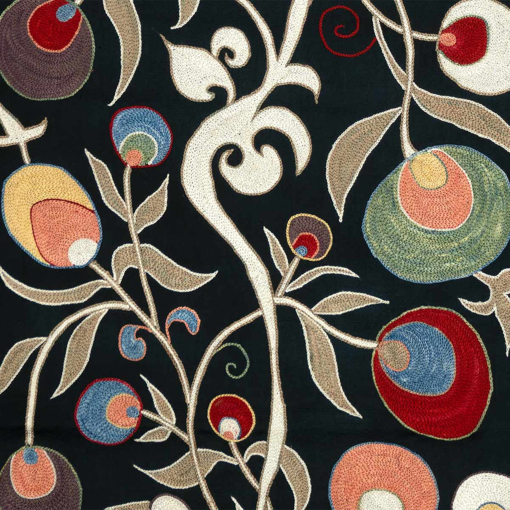 Close up view of Mekhann's black pomegranate silk artwork, where the pomegranate motifs and vine details are set against the silk black, showcasing the contrast and craftsmanship.