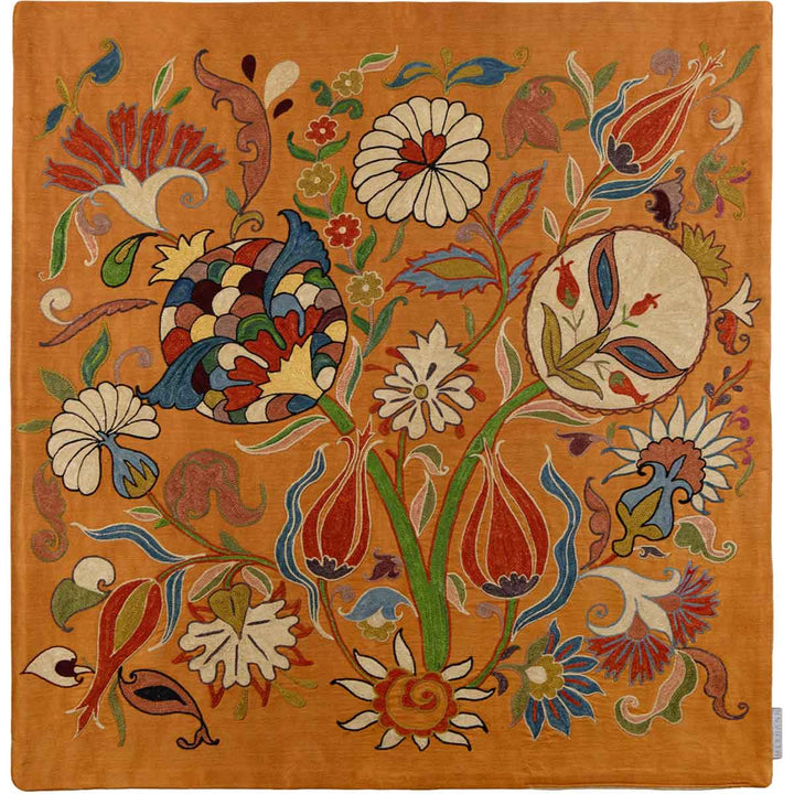 Front view of Mekhann's iznik caramel petite throw, featuring a vibrant Iznik-inspired pattern with rich reds, blues, and greens spread across the fabric, all hand embroidered onto a caramel coloured silk base.