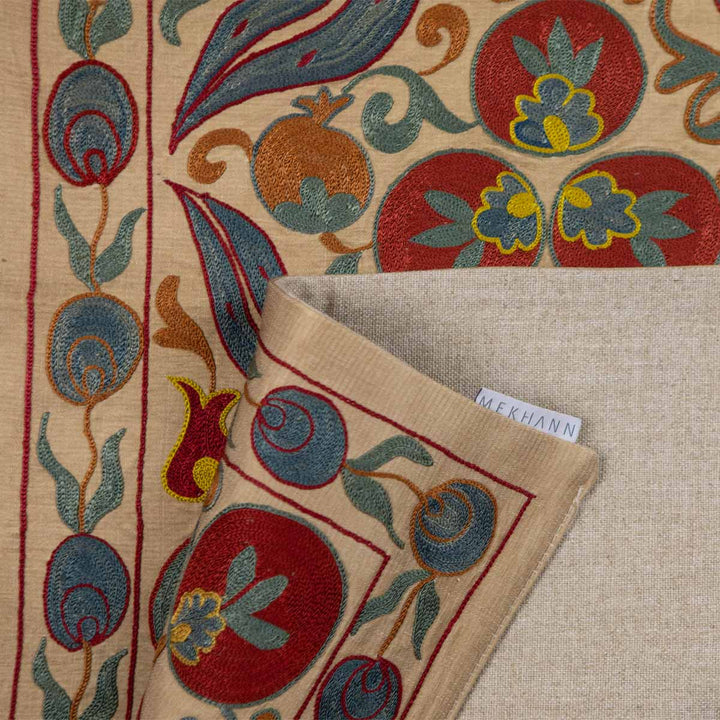 Folded view of Mekhann's multicoloured cintamani runner, showing the back lining in full display in a beige.