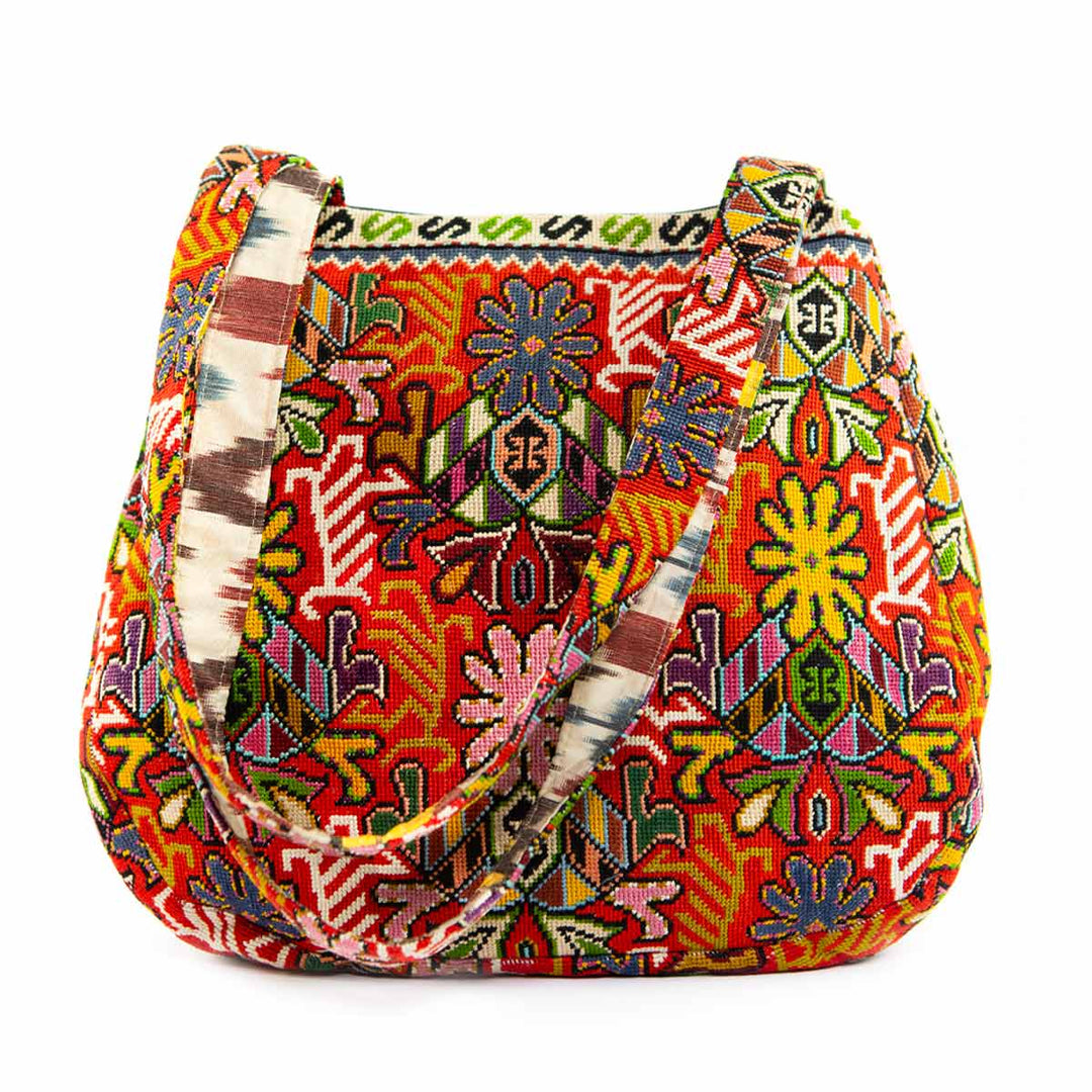 Front view of Mekhann's multicoloured shoulder bag, showing all the embroidered floral details on the front side of the bag.