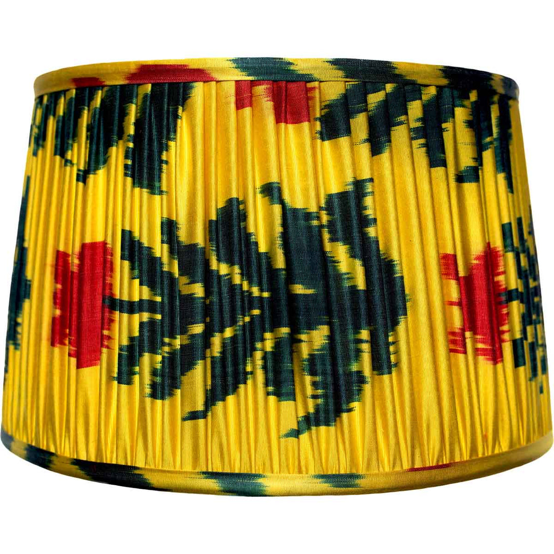 Yellow lampshade with dark blue and red abstract pattern on a white background