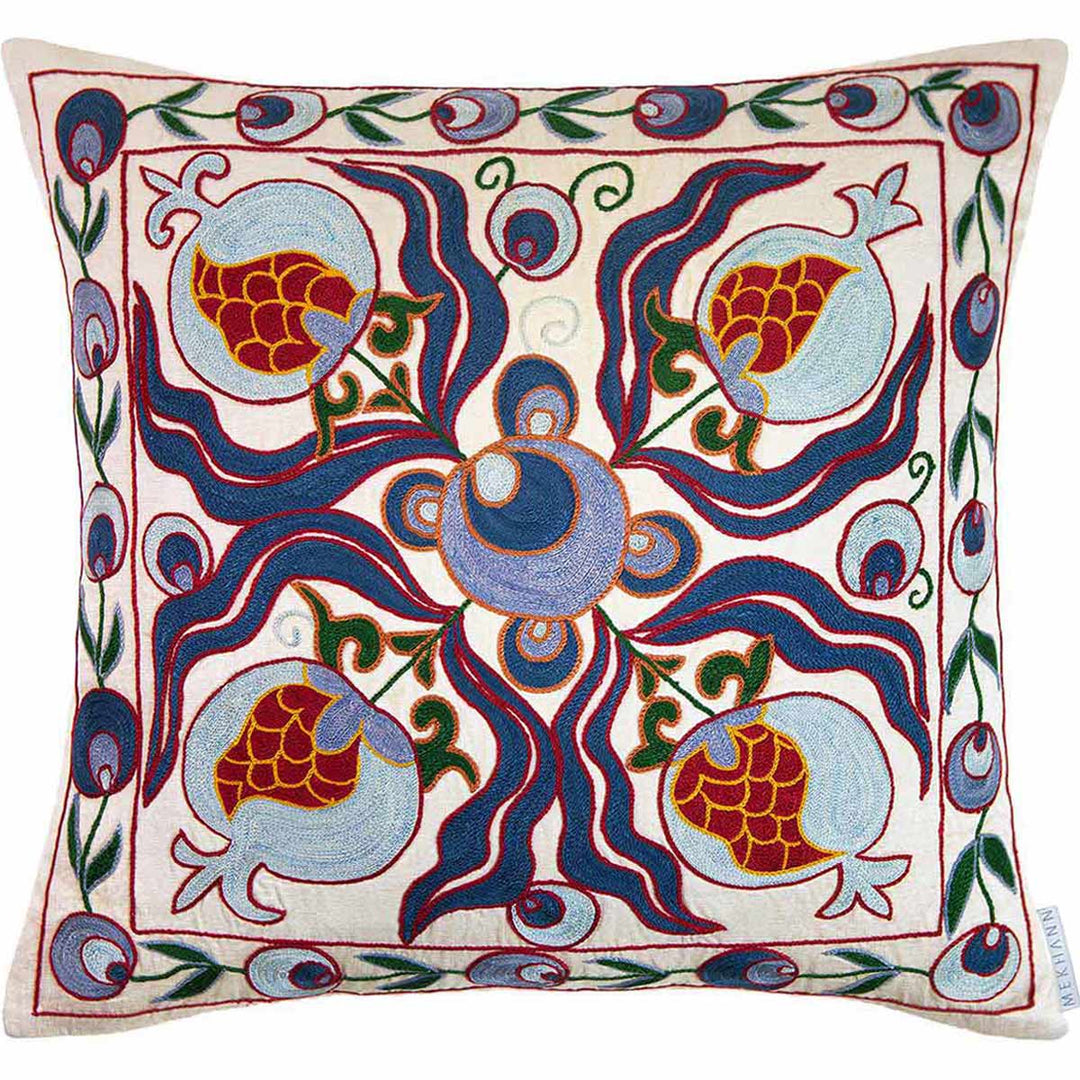 Front view of Mekhann's blue and multicoloured embroidered cushion, where the full composition of patterns can be seen, including traditional Cintamani patterns and pomegranate patterns. All motifs have been hand embroidered onto a cream silk canvas.