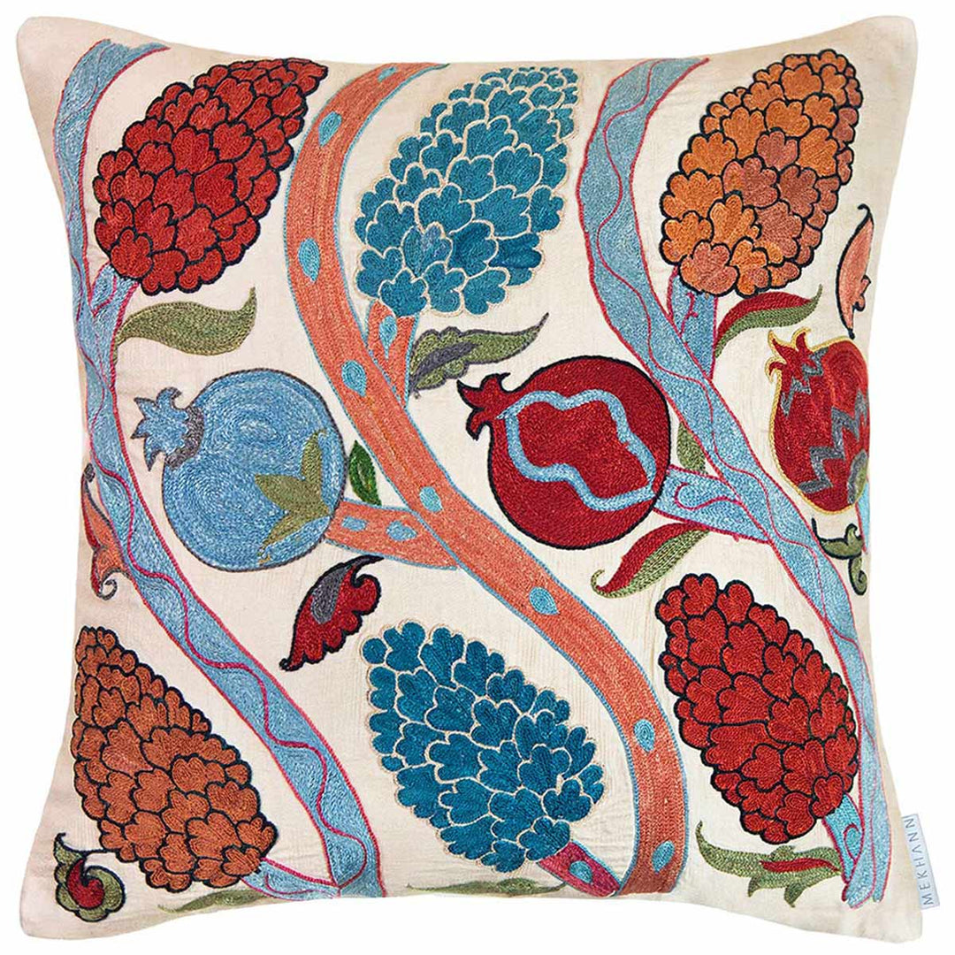 Front view of Mekhann's cream Grapes and Pomegranates embroidered cushion, where we can see a collection of pomegranate and grapes growing grove vines. All motifs have been hand embroidered in red, blue, brown and light green on a canvas of cream coloured silk.