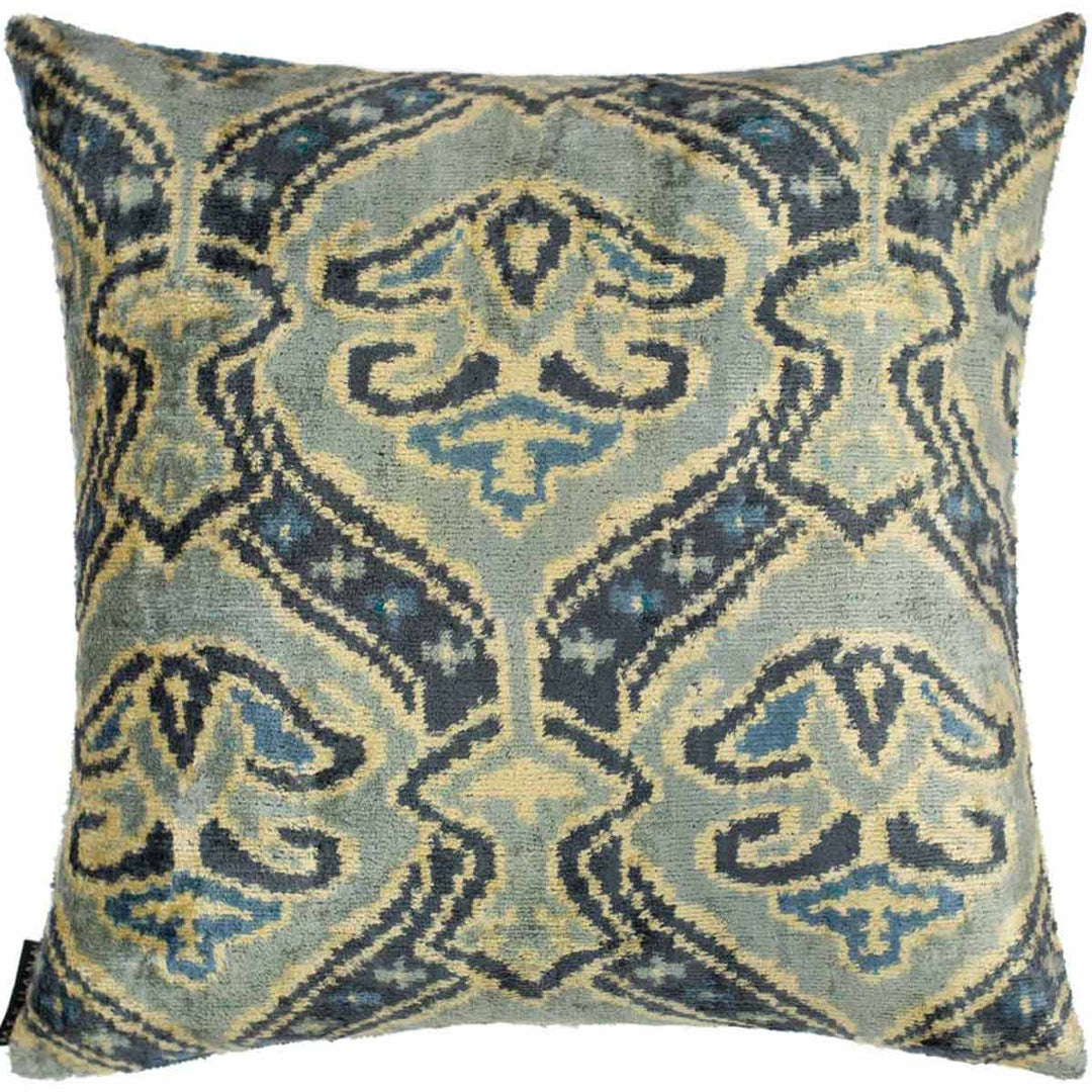 Front view of Mekhann's light green velvet cushion, showcasing a playful patterns of abstract shapes in various green tones.