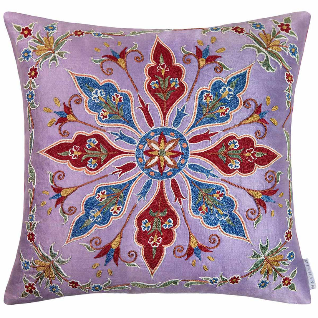 Front view of Mekhann's multicoloured abstract embroidered cushion, showing a collection of abstract embroidered patterns on a light purple silk base.