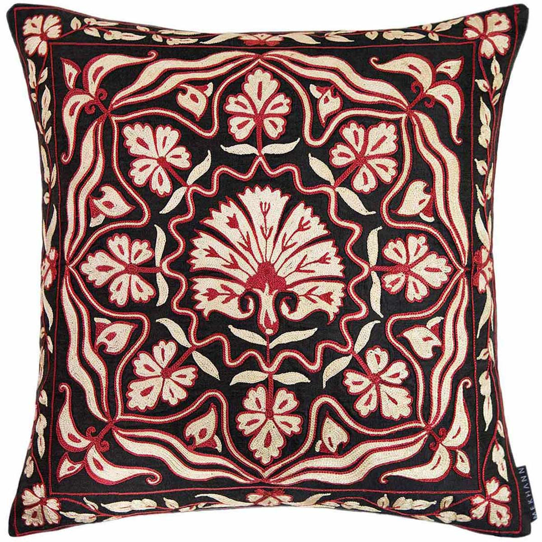 Front view of Mekhann's red and black carnations embroidered cushion, showcasing one large central carnation motif surrounded by many smaller carnations that have all been hand embroidered in red and cream silk yarns on a canvas of black silk.
