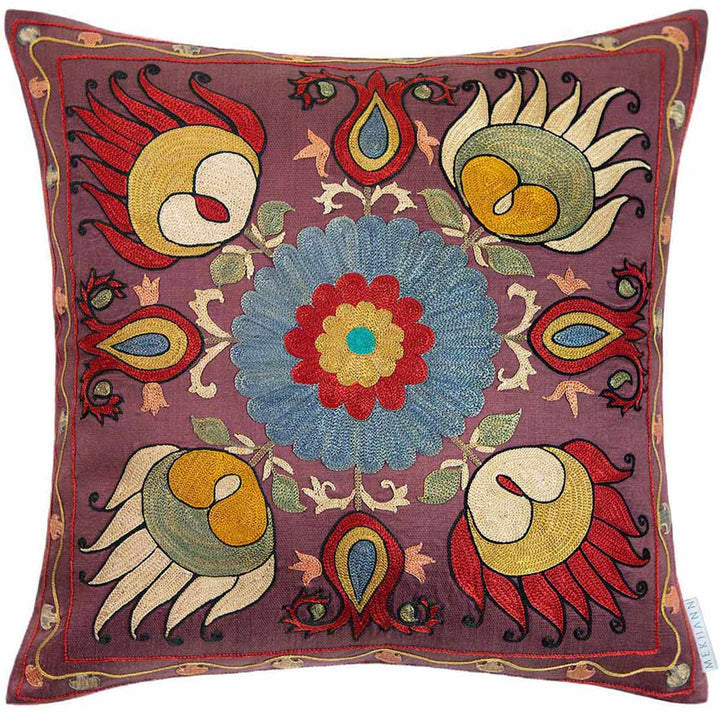 Front view of Mekhann's multicoloured lotus embroidered cushion, where we can see a collection of four main lotus designs that have been hand embroidered in bright bred, green and yellow with a black outline. All have been embroidered onto a dark purple silk base.