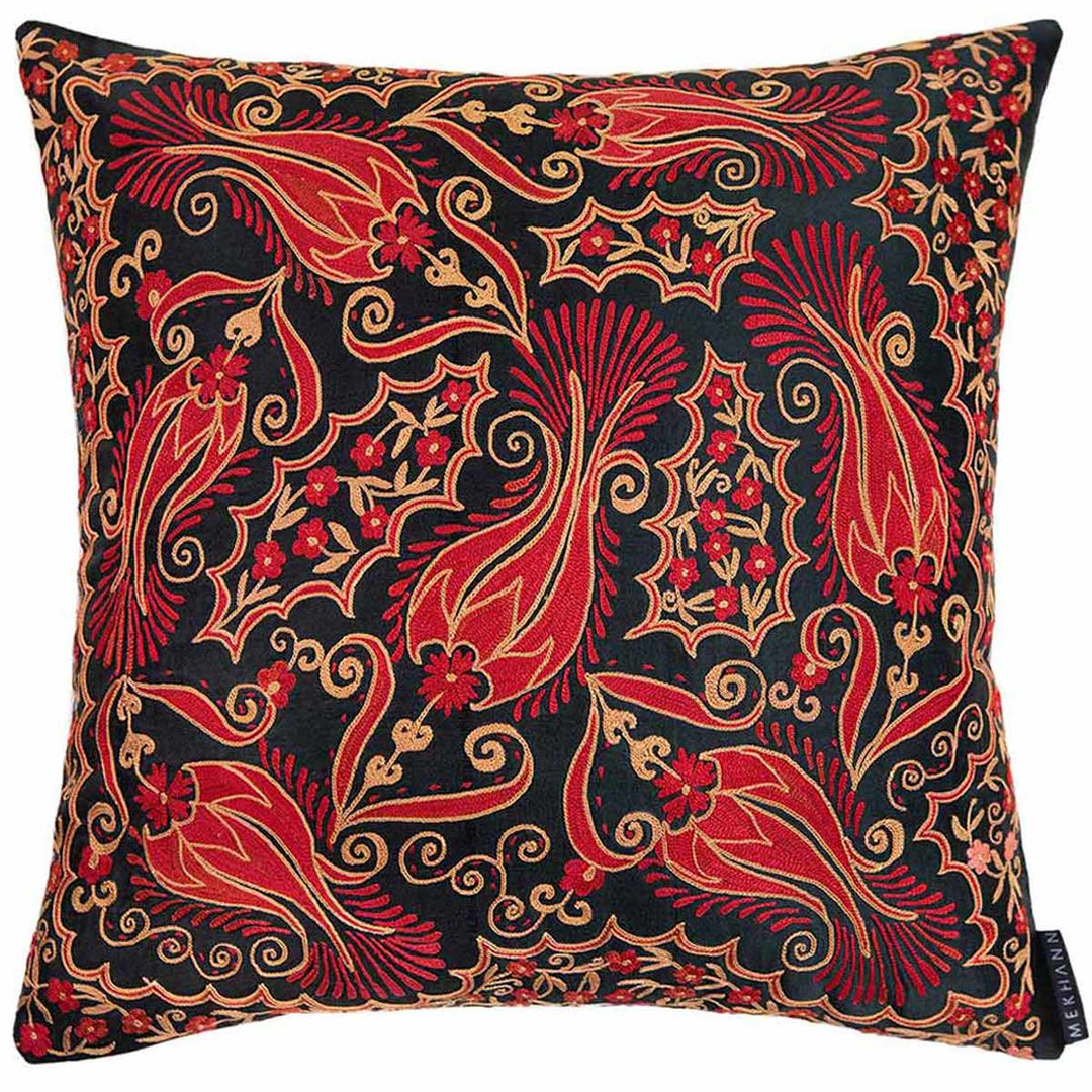 Front view of Mekhann's red and black iznik embroidered cushion, showing the full composition of flower designs that have been hand embroidered using red and beige silk yarns that stand out against the black silk lining.