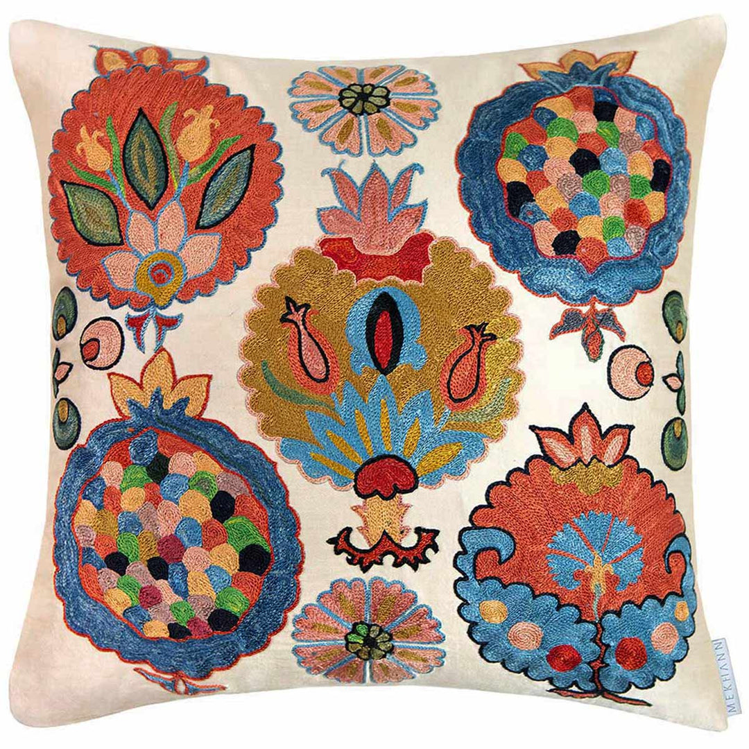 Front view of Mekhann's Topkapi embroidered cushion, showcasing a collection of colourful iznik botanical embroidered patterns all hand embroidered on a base of cream coloured silk.