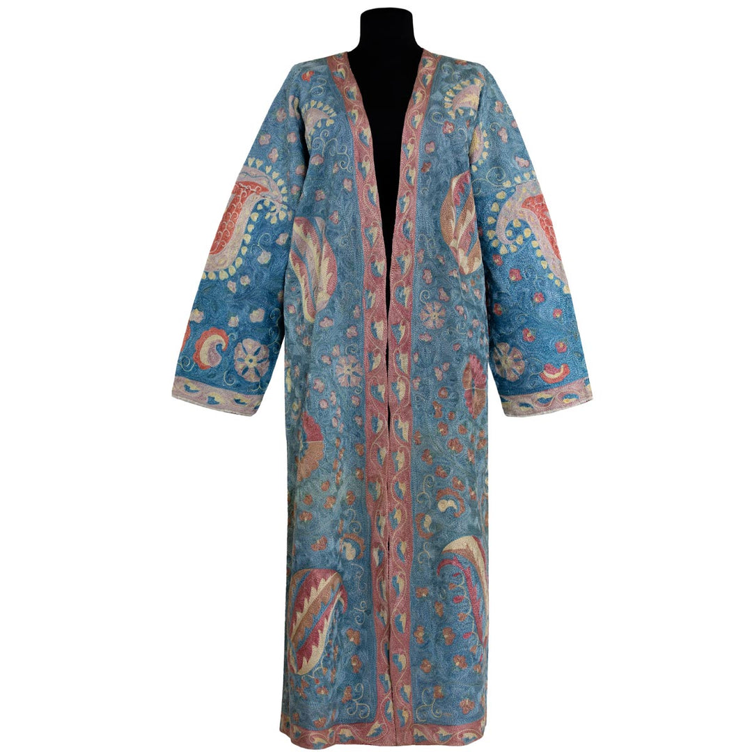 Front view of Mekhann's fully embroidered lividus II kaftan in navy, showcasing a soft colour palette of light pinks, blues and cream that have been fully hand embroidered with attention to detail.