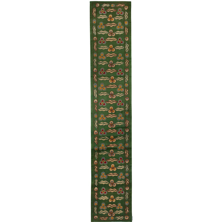 Front view of Mekhann's green cintamani runner, a celebration of hand embroidered cintamani patterns surround by other decorative elements that cover the entirety runner, all patterns have been hand embroidered on a base of green coloured silk.