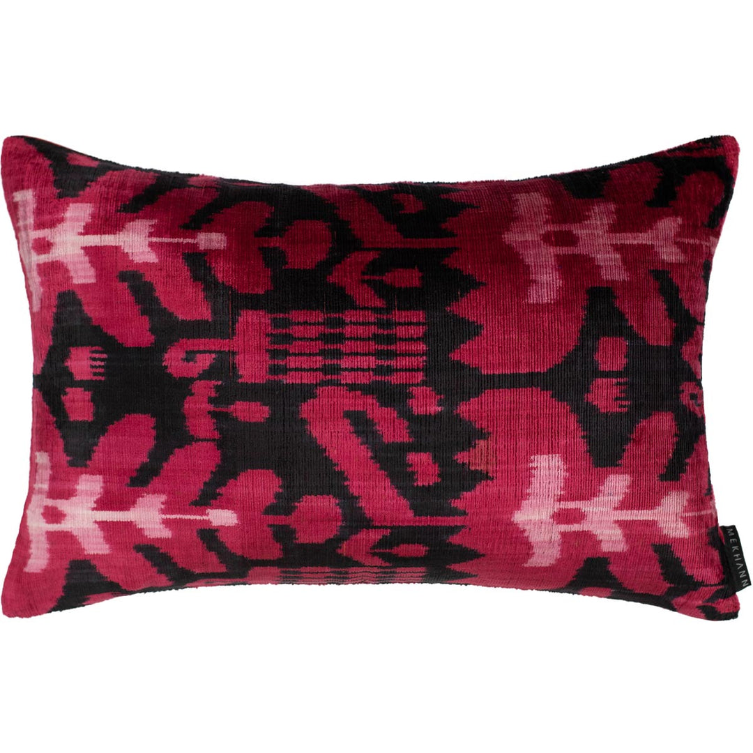 Handwoven silk velvet Ikat cushion in fuchsia and black, showcasing the Sagitta pattern with rich, naturally dyed tones.