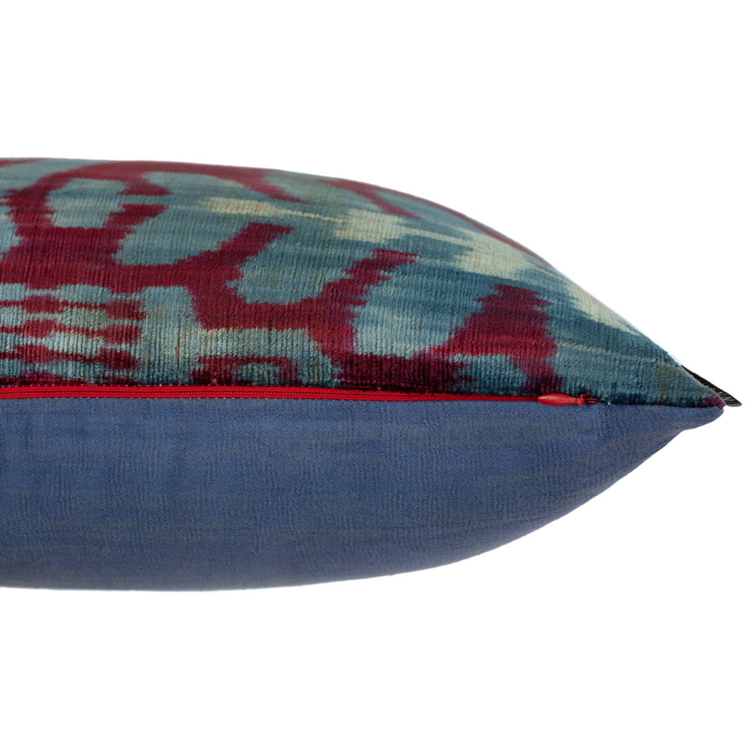 Side view of handwoven silk velvet Ikat cushion in royal purple and azure, highlighting the plush texture, intricate Sagitta pattern, and expert craftsmanship.