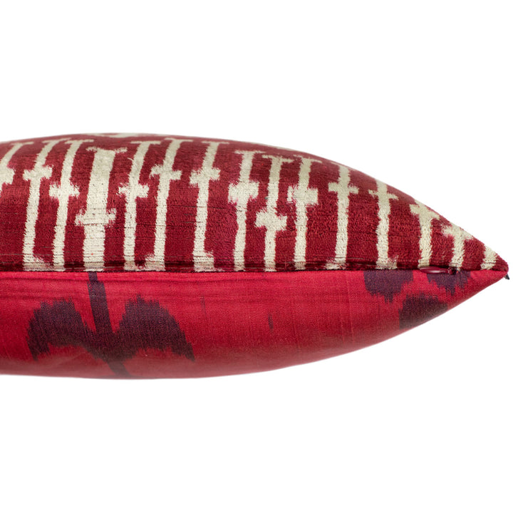 Side view of a handwoven silk Ikat cushion showcasing the contrast between the bold Spearhead velvet Ikat front and the delicate Carnation silk back