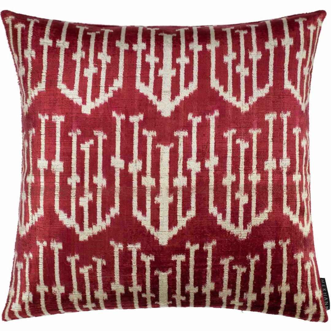 Handwoven silk velvet Ikat cushion in deep crimson and burgundy, featuring the Spearhead motif with bold geometric precision and traditional resist-dyeing craftsmanship