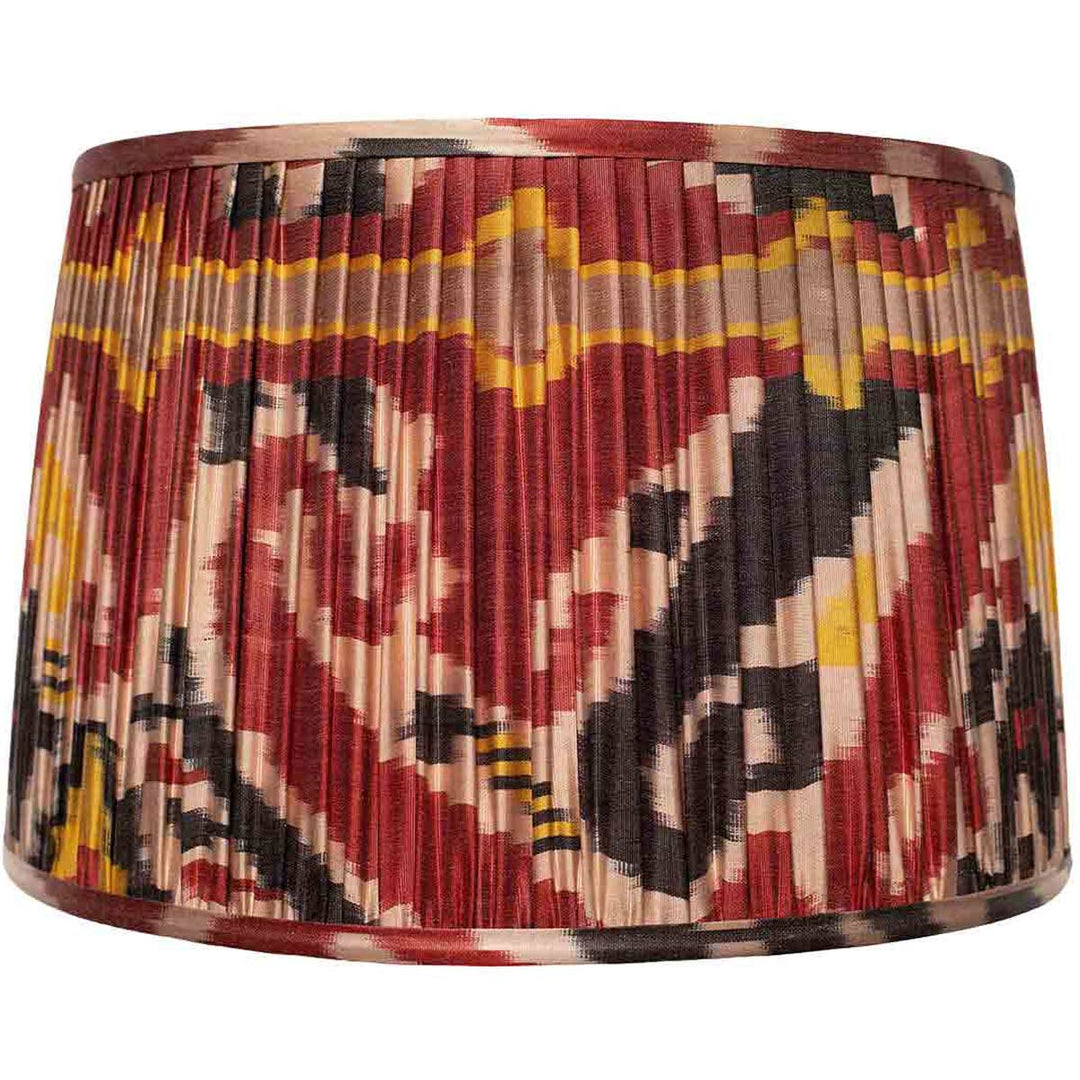 Mekhann's large red ikat silk lampshade, a luxurious home accessory hand-pleated using sustainable dyes for an exquisite finish.