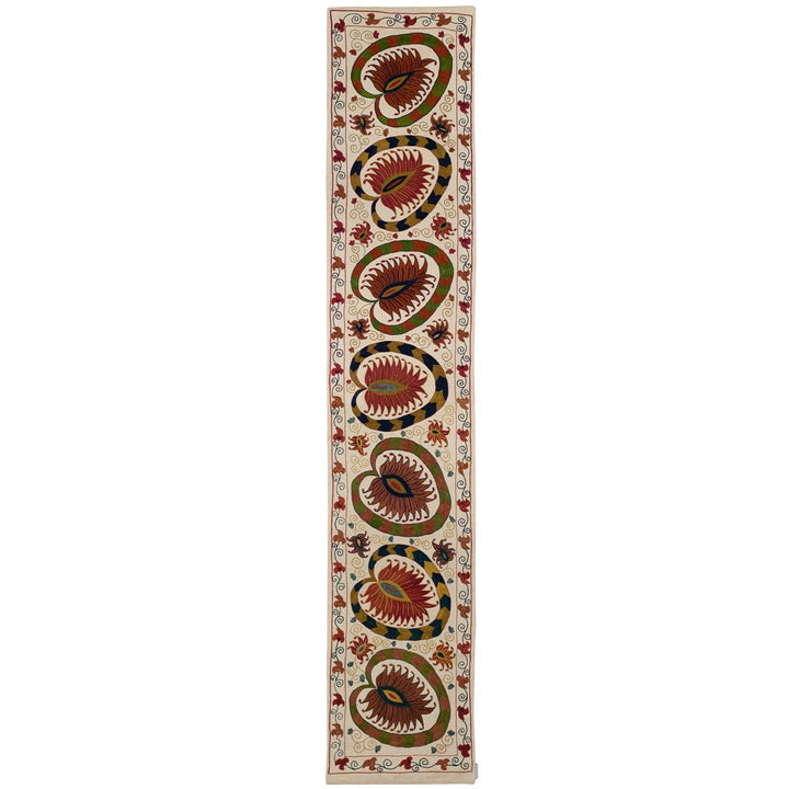 Front view of Mekhann's cream lotus runner, showing in full the hand embroidered lotus patterns in warm earthy hues embroidered onto a canvas of cream coloured silk.