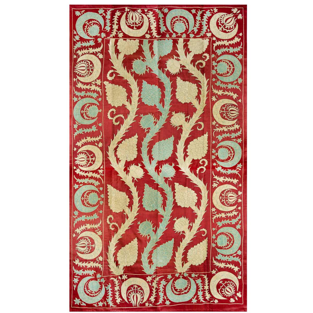 Front view of Mekhann's maroon grape vines throw, displaying the light blue and cream vines embroidered against the vibrant maroon silk backdrop.